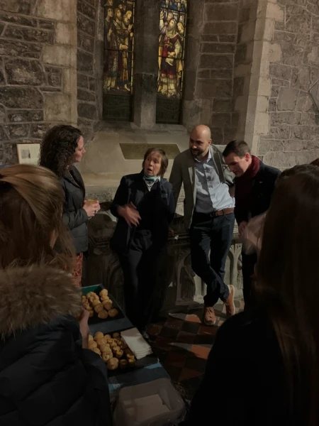 A group of visitors at a guided tour of St Canice's Cathedral.