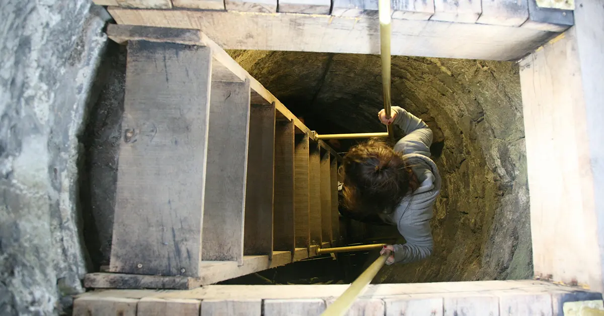 A kid climbs the Round Tower at St. Canice's Cathedral.