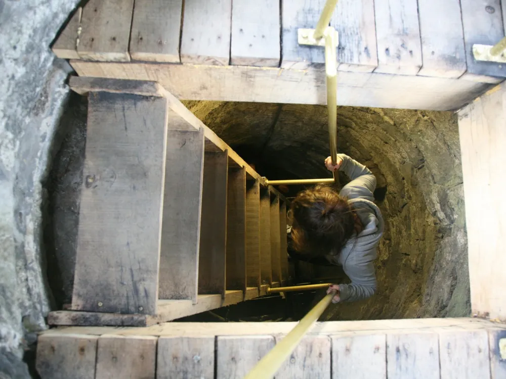 A kid climbs the Round Tower at St. Canice's Cathedral.