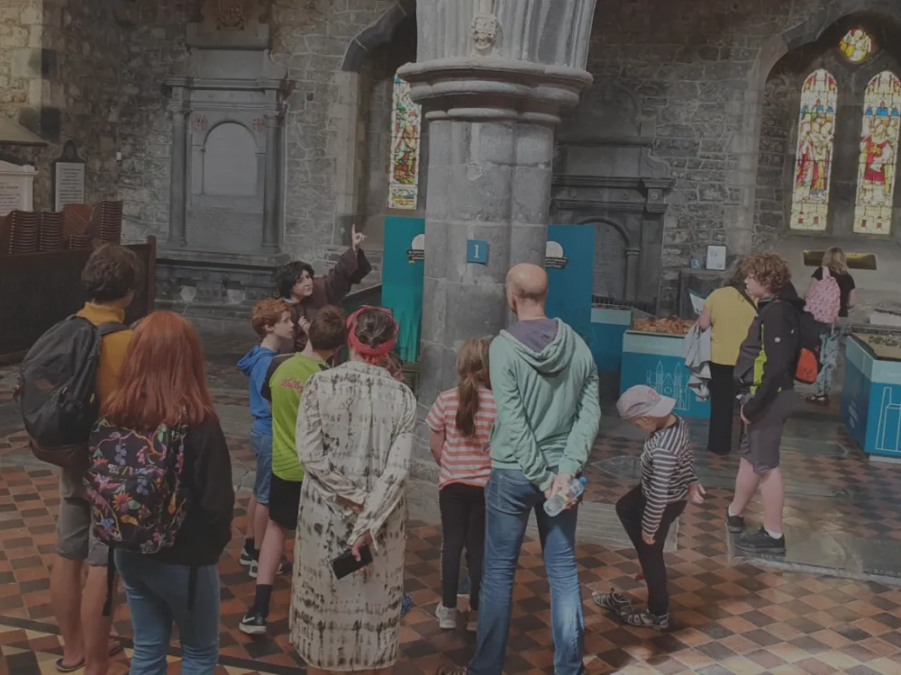 Students participating in a school tour at St. Canice's Cathedral, exploring its history and architecture.