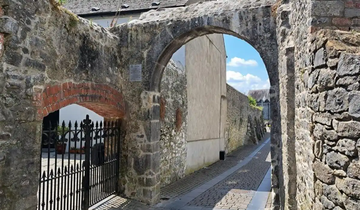 View of the Black Freren Gate and medieval city walls in Kilkenny, Ireland, showcasing historic architecture.